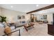 Cozy living room displaying a fireplace, a wooden beam, and large window at 8433 S Painted Sky St, Highlands Ranch, CO 80126
