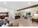 Open-concept living room with views of the kitchen, hardwood floors, and a cozy atmosphere at 8433 S Painted Sky St, Highlands Ranch, CO 80126