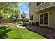Well-maintained backyard with a patio seating area, green lawn, and attractive landscaping at 2146 S Ellis Ct, Lakewood, CO 80228