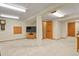Spacious basement with carpeted floors, wooden doors, and a TV area ready for entertainment at 2146 S Ellis Ct, Lakewood, CO 80228