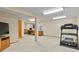 Basement with carpeted floors includes a treadmill, workspace, and neutral walls and lighting at 2146 S Ellis Ct, Lakewood, CO 80228