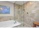 Spa bathroom with large shower, separate tub, and tile floors at 2146 S Ellis Ct, Lakewood, CO 80228