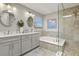 Bright bathroom features a double sink vanity, a shower, and a separate bathtub at 2146 S Ellis Ct, Lakewood, CO 80228