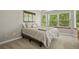 Relaxing bedroom with a ceiling fan, carpet floors, and large windows at 2146 S Ellis Ct, Lakewood, CO 80228
