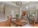 Elegant dining area with a large wooden table, chandelier lighting, and views into the living room at 2146 S Ellis Ct, Lakewood, CO 80228