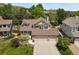 Charming two-story home with a three-car garage, manicured landscaping, and mature trees at 2146 S Ellis Ct, Lakewood, CO 80228
