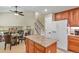 Bright kitchen with granite island, wood cabinets, stainless appliances, and an open layout for entertaining at 2146 S Ellis Ct, Lakewood, CO 80228