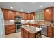 Beautiful kitchen featuring wood cabinets, granite countertops, stainless steel appliances, and a center island at 2146 S Ellis Ct, Lakewood, CO 80228