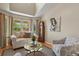 Cozy living room featuring large windows, vaulted ceilings, comfortable seating, and a decorative area rug at 2146 S Ellis Ct, Lakewood, CO 80228