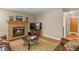 Bright living room with a brick fireplace, a neutral color palette, and hardwood floors at 2146 S Ellis Ct, Lakewood, CO 80228