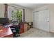 Well-lit home office featuring carpet floors, a large window, and a closet for storage at 2146 S Ellis Ct, Lakewood, CO 80228