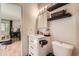 Bright bathroom featuring a modern vanity, sleek fixtures, and a door to the bedroom at 8225 Fairmount Dr # 104, Denver, CO 80247