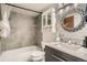 Modern bathroom with gray tile, a luxurious vanity, and updated fixtures, offering a spa-like experience at 8225 Fairmount Dr # 104, Denver, CO 80247