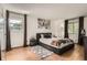 Inviting bedroom featuring stylish decor, natural light, and sleek black accents at 8225 Fairmount Dr # 104, Denver, CO 80247