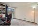 Bedroom offers a versatile space with natural light and a sliding glass door to a balcony at 8225 Fairmount Dr # 104, Denver, CO 80247
