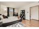 Comfortable bedroom with a sleek platform bed, large TV, and a view to the outside at 8225 Fairmount Dr # 104, Denver, CO 80247