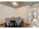 Cozy dining room with a round table, comfortable seating, and easy access to the hallway at 8225 Fairmount Dr # 104, Denver, CO 80247