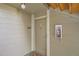Condo entrance with visible unit number, fire extinguisher, and door at 8225 Fairmount Dr # 104, Denver, CO 80247