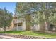 Apartment building featuring two stories with balconies and attractive landscaping at 8225 Fairmount Dr # 104, Denver, CO 80247