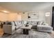 Inviting living room showcasing a comfortable, oversized sectional and stylish decor at 8225 Fairmount Dr # 104, Denver, CO 80247