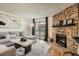 Bright living room with stone fireplace, sliding glass doors to the outside, and contemporary decor at 8225 Fairmount Dr # 104, Denver, CO 80247