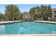 Inviting community pool with pool house and chairs, creating an oasis at 8225 Fairmount Dr # 104, Denver, CO 80247