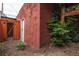 Backyard view of a detached structure with a door, side of building, and green shrubs at 131 Fox St, Denver, CO 80223
