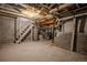 Unfinished basement area with stairs and utilities, offering potential for customization at 131 Fox St, Denver, CO 80223