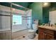 Elegant bathroom featuring white tiles, a glass-enclosed shower, granite counters, and a tiled floor at 131 Fox St, Denver, CO 80223