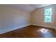 Bright bedroom with hardwood floors, a window, and neutral walls ready for personalization at 131 Fox St, Denver, CO 80223