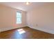 Sunlit bedroom featuring a window, hardwood floors, neutral walls, and a closet at 131 Fox St, Denver, CO 80223