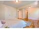 Spacious bedroom with multiple doorways, hardwood floors, white trim, and ample natural light at 131 Fox St, Denver, CO 80223