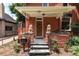 Inviting front porch featuring decorative lion statues, creating a grand entrance to the home at 131 Fox St, Denver, CO 80223