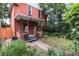 Charming two-story home with a landscaped front yard and lion statues on the porch at 131 Fox St, Denver, CO 80223