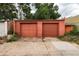 Two-car garage with red doors and concrete driveway; good for parking and storage at 131 Fox St, Denver, CO 80223