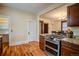 Traditional kitchen with granite counters, stainless appliances, wooden cabinets and dining room at 131 Fox St, Denver, CO 80223