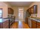 Traditional kitchen with wood floors, granite counters, stainless appliances and wooden cabinets at 131 Fox St, Denver, CO 80223