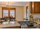 Granite countertop island with stainless gas cooktop stove, wooden floors and dining area at 131 Fox St, Denver, CO 80223