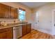 Traditional kitchen with granite counters, stainless appliances, wooden cabinets and wood floors at 131 Fox St, Denver, CO 80223