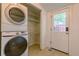 Functional laundry room with washer/dryer, wire shelving, and access to the outdoors at 131 Fox St, Denver, CO 80223