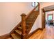 Wooden staircase with dark wood trim and decorative molding detail at 131 Fox St, Denver, CO 80223