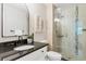 Modern bathroom with a sleek vanity, black hardware and a glass-enclosed shower at 3470 S Poplar St # 404, Denver, CO 80224