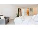 Cozy bedroom featuring soft carpet, a large mirror, and ensuite bathroom access at 3470 S Poplar St # 404, Denver, CO 80224