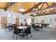 Bright community room with tables, chairs, wood ceilings, and plenty of space for gatherings at 3470 S Poplar St # 404, Denver, CO 80224