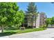 Exterior view of Morningside Condominiums, showcasing lush landscaping and building facade at 3470 S Poplar St # 404, Denver, CO 80224