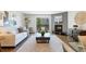 Inviting living room features a cozy fireplace and balcony overlooking lush greenery at 3470 S Poplar St # 404, Denver, CO 80224