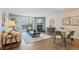 Inviting living room with a fireplace, balcony access, and warm wooden floors at 3470 S Poplar St # 404, Denver, CO 80224