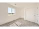 Cozy bedroom showcasing plush carpeting, a double door closet, and a large window for natural light at 1290 S Algonquian St, Aurora, CO 80018