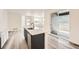 Stylish kitchen island with stainless steel dishwasher and a sink featuring light countertops and views of the backyard at 1290 S Algonquian St, Aurora, CO 80018