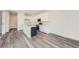 Open concept kitchen with white cabinets, stainless steel appliances, kitchen island, and modern gray flooring at 1290 S Algonquian St, Aurora, CO 80018